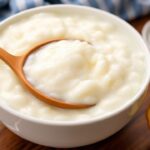 Creamy rice pudding with condensed milk, a sweet, silky embrace.