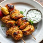 Grilled Greek souvlaki skewers with vibrant homemade tzatziki, a perfect summer meal.