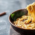 Authentic shoyu ramen broth simmering, a guide to home preparation.