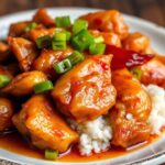 Golden crispy chicken, vibrant sweet sour sauce, authentic Chinese dish.