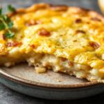 Golden Spanish tortilla, a comforting potato omelette, sliced on a rustic plate.